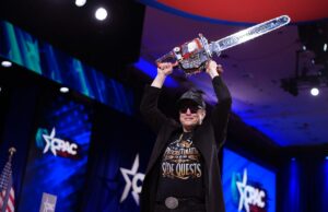 Elon Musk said he could continue to do doge for Trump’s remaind CEO of Tesla and SpaceX Elon Musk holding a chainsaw above his head.