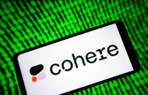 O ano de US$ 240 milhões da Cohere prepara o terreno para o IPO Image of a phone with Cohere's logo on it with a green digital background.