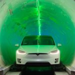 white tesla coming out of the boring company tunnel