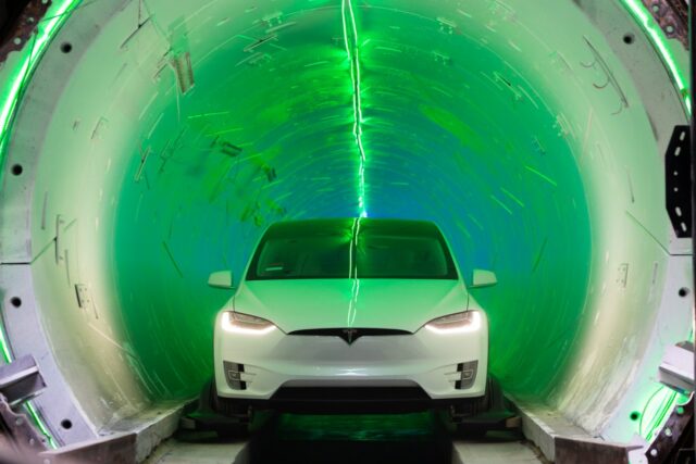 white tesla coming out of the boring company tunnel