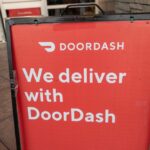 Sign reading We Deliver With Doordash, referencing the Doordash food delivery service, San Ramon, California, September 12, 2020. (Photo by Smith Collection/Gado/Getty Images)