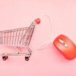 small shopping cart and red computer mouse