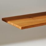 A plank of InventWood Superwood stands against a white background.