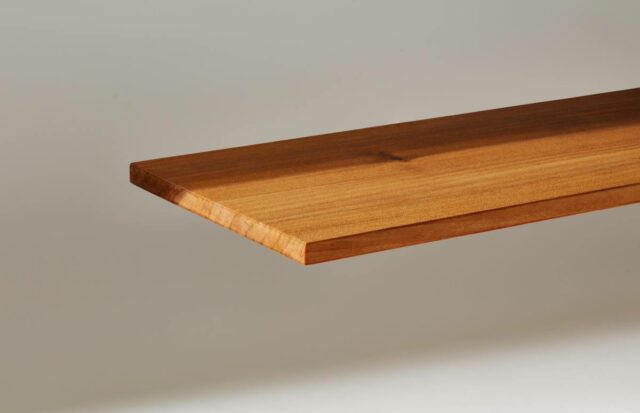 A plank of InventWood Superwood stands against a white background.