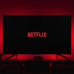 netflix logo on black screen backlit by red glow