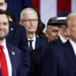 Apple CEO Tim Cook (C) seen behind US President Donald Trump (R) and US Vice President JD Vance (L) after the two were sworn into office at an inauguration ceremony in the rotunda of the United States Capitol on January 20, 2025 in Washington, DC.