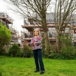 Martine Le Barth em frente à sua casa, com o novo desenvolvimento de moradias atrás dela em South Molton Devon