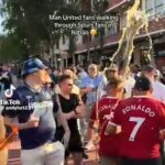 Dois fãs do Man United estavam encharcados de cerveja enquanto caminhavam pelas ruas de Bilbao