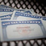 a close up shot of several Social Security cards on a chequered mat.