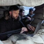 Man at laptop in a defense bunker