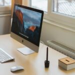 Essa teoria no dispositivo de hardware Jony Ive parece cada vez mais provavelmente | Uma mesa com iMac, teclado, mouse, suporte à caneta e caixa