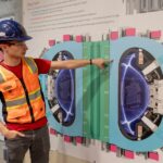 Alex Creely, director of Tokamak operations at Commonwealth Fusion Systems, points to a reactor schematic.
