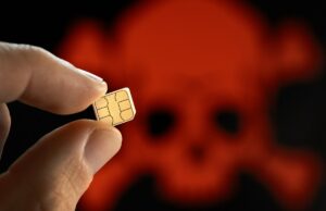 Como proteger o número do seu celular contra o SIM Swap A close up shot of a person holding a SIM card, with a skull in the background to demonstrate SIM hack