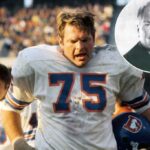 Denver Broncos luta com Roger Shoals (75) na linha lateral.