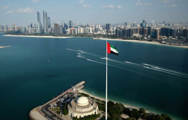 UAE flag flying in front of ocean/skyline chips