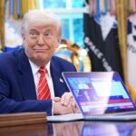 President Donald Trump,shows a news video from a laptop in the Oval Office of the White House on May 30, 2025 in Washington, DC.