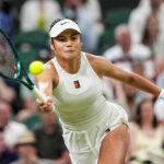 LONDON, ENGLAND - JULY 04: Emma Raducanu of United Kingdom plays a forehand in the Ladies' Singles Third Round match against Aryna Sabalenka on day five of The Championships Wimbledon 2025 at All England Lawn Tennis and Croquet Club on July 04, 2025 in London, England. (Photo by Shi Tang/Getty Images)