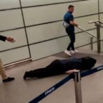 Tommy Robinson passa por um homem que parece ter ficado inconsciente em St Pancras na noite passada