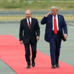 Pode haver uma razão sinistra por trás de Vladimir Putin andou com um braço ao seu lado quando ele conheceu Donald Trump na semana passada