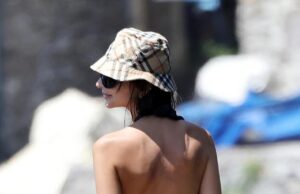 O Emily Ratajkowski foi flagrada batendo na praia em um maiô preto sem costas, que pouco fez para cobrir seu traseiro enquanto estava de férias em Postiano no início deste mês