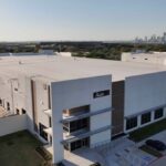 Aalo Atomics factory seen from the air with Austin's skyline in the background.