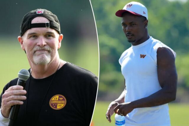 Dan Quinn, o principal treinador dos comandantes de Washington, falando com o microfone.