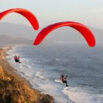 Os pilotos de parapente conquistaram Bonaparte, Top, e sua namorada Bonita Hudson, ambos de Pacifica, desfrutam do clima enquanto o sol se põe no horizonte em Mussel Rock Beach, em Daly City, Califórnia, na quinta -feira, 21 de agosto de 2025. Hudson e Bonaparte estão voando há 16 e 12 anos, respectivamente, respectivamente. No início do dia, Hudson voou de uma elevação mais alta. (Ray Chavez/Bay Area News Group)