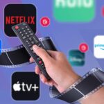 Um balde de pipoca com diferentes logotipos de serviço de streaming ao seu redor.