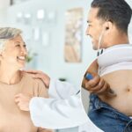 A mulher se injeta no estômago com a ajuda de Oz.