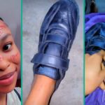 A senhora nigeriana mostra um presente de sapato do palco, as pessoas não param de falar
