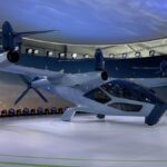 an electric air taxi paint in white sits on a platform at CES 2024