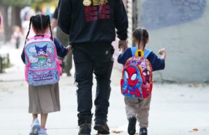 As escolas públicas da cidade de Nova York estão focadas na ideologia – e em crianças fracassadas Homem andando dois filhos para a escola.