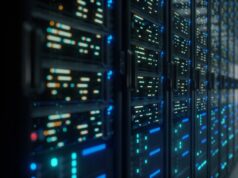 Os acordos de infraestrutura de bilhões de dólares que impulsionam o boom da IA Modern data center with servers with lights on them.