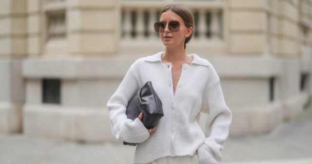 Diane Batoukina usa óculos de sol pretos, uma camiseta preta, um casaco de couro brilhante marrom escuro, um cinto pequeno de couro preto e preto de couro de grão de grão de Hermes, calças grandes pretas, uma bolsa preta de couro brilhante e atemporal de Chanel, saltos de couro preto em parais em parais em parais em dia 262222222.