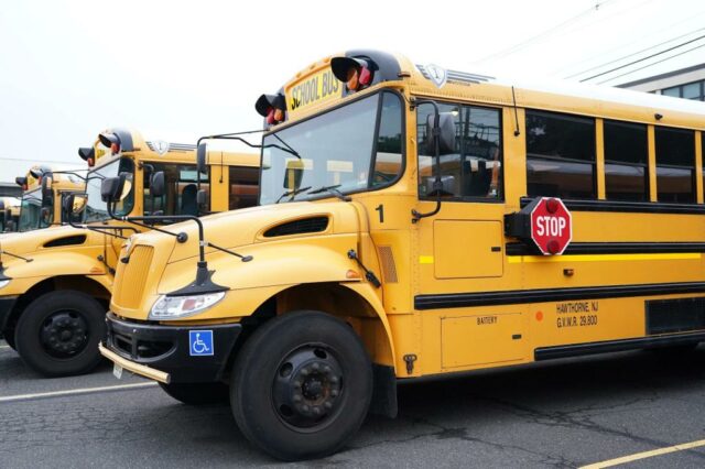 Ônibus escolares amarelos estacionados em um estacionamento do ensino médio em Hawthorne, NJ