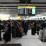 Travellers wait in terminal 4 at Heathrow Airport, west of London on September 20, 2025. Major European airports including Brussels, Berlin and London's Heathrow were Saturday hit by "cyber-related disruption" affecting check-in and baggage drop systems and causing delays, airport service provider Collins Aerospace told AFP.