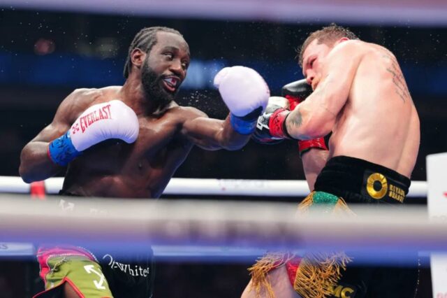 Terence Crawford (à esquerda) Punches Canelo Alvarez a caminho do título de super médio médio de 13 de setembro de 2025 em Las Vegas.