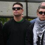 Liam Óg Ó hAnnaidh, aka Mo Chara, right, a member of the Irish language band Kneecap, celebrates as he leaves Woolwich Crown Court in London, Friday, Sept. 26, 2025, after Chief Magistrate, Senior District Judge Paul Goldspring, dismissed a terrorism offence relating to displaying a flag in support of Hezbollah during a performance with the band in November 2024, on a technical error.
