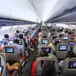 Passengers seated on a plane.