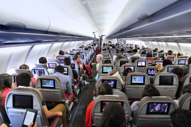 Passengers seated on a plane.