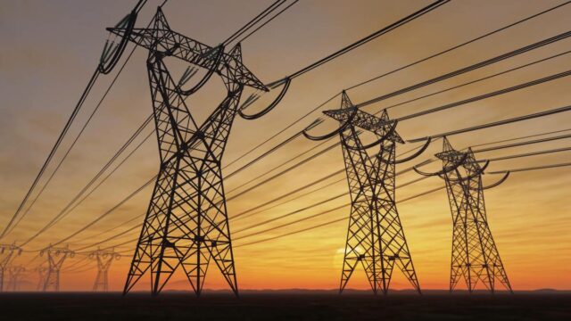 Power lines loom on the horizon at sunset.