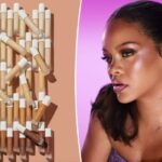 Um frasco de base Fenty Beauty próximo aos braços com vários tons de pele apresentando diferentes tons de base.