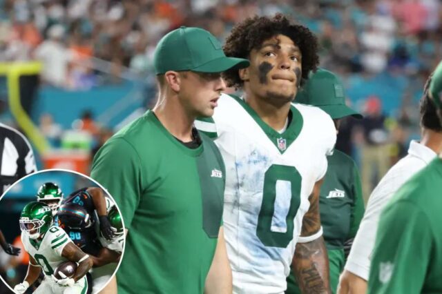 Braelon Allen sendo retirado do campo por treinadores.