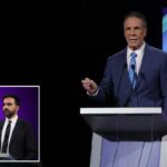 Andrew Cuomo falando em um debate para prefeito com um intérprete de ASL.