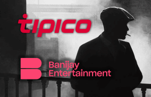 Banijay, fabricante de Peaky Blinders, fecha oferta de US$ 5 bilhões para produzir grandes apostas O produtor de Peaky Blinders, Banijay, fecha acordo de US$ 5 bilhões para criar gigante do jogo. Silhueta de um homem fumando com boné chato, uma reminiscência do estilo Peaky Blinders, com os logotipos Tipico e Banijay Entertainment sobrepostos em vermelho e rosa.