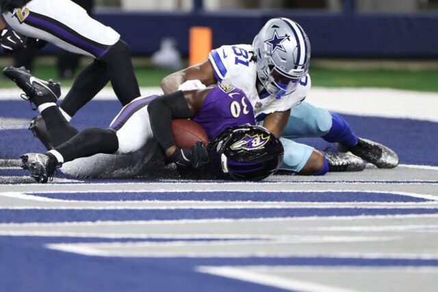 Reuben Lowery #30 of the Baltimore Ravens intercepts a pass intended for Jonathan Mingo #81 of the Dallas Cowboys