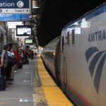 NEWARK, NJ - JUNE 14: People wait to board an Amtrak train at Penn Station on June 14, 2025, in Newark, New Jersey.