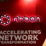 a photo showing Ribbon Communicatons' signage on a red background