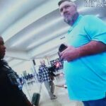 Esta imagem feita a partir de 20 de outubro de 2025, imagens da câmera do corpo policial mostram Billy Joe Cagle, de Cartersville, Geórgia, à direita, conversando com policiais antes de ser preso dentro do terminal doméstico do Aeroporto Internacional Hartsfield-Jackson Atlanta, em Atlanta. (Departamento de Polícia de Atlanta via AP)