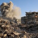Amigos e parentes lamentam o corpo amortalhado de um homem morto em um ataque israelense no centro da Faixa de Gaza no domingo. - Bashar Taleb/AFP/Getty Images